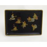 An Oriental lacquered tray having 7 immortals as decoration .