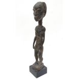 Ethnographic Native Tribal: A dark patinated African figure standing,