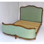 A Louis XV style bed with shaped head and footboard with floral carving matching the rosette carved