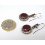 A pair of silver drop earrings with gilt red and white stone decoration 1 1/4" long