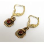 A pair of vintage gilt metal earrings set with red paste stones CONDITION: Please