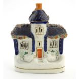 A Staffordshire pottery model of a flat back house. Approx. 6 1/2" tall x 4 1/2" wide.