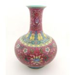 A Chinese famille rose baluster vase decorated with flowers and foliage,