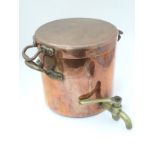 Harrods : A copper and bronze handled lidded stove top hot water can with brass tap.