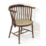 An early / mid 20thC tub chair with slatted supports,