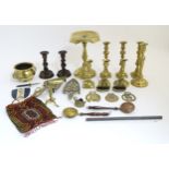 A box containing assorted brass items etc to include a goffering iron, various candlesticks,