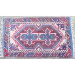 Rug carpet: A handmade rug having blue, cream, light red, wine red, yellow/orange colours,