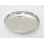 A silver pin dish of circular form. Hallmarked London 1942, maker Edward Barnard & Sons Ltd.