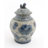 An oriental blue stoneware ginger jar with a foo dog to the top of the lid CONDITION: