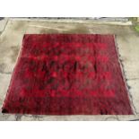 Rug carpet: A large handmade rug with wine, orange, black colours,