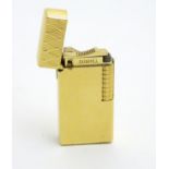 Collectors lighter - Dunhill : A gold plated machined gas lighter 2 5/16" high