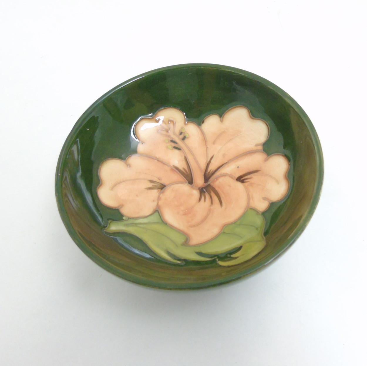 A Moorcroft Hibiscus pottery bowl dish, with pink hibiscus design on green ground, - Image 4 of 6