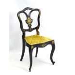A Victorian chair stamped 'Jennings and Betteridge' with black lacquered finish and gilt painted