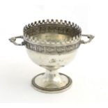 WMF: A silver plate pedestal cup with twin handles and embossed decoration.