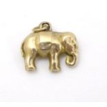 A vintage yellow metal charm / pendant formed as a elephant 1/2" wide CONDITION: