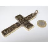 A white metal cross / crucifix with cast religious scenes within and gilt detail.