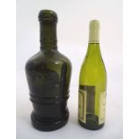 A large olive green bottle , circa 1820 ,