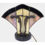 Lighting: An Art Deco electric table lamp with cast metal figures against stained glass,