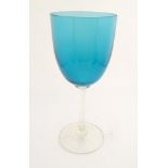 An oversized wine glass with a turquoise bowl, 13" high.