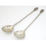A pair of Continental white metal spoons with twist handles.