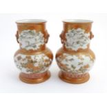 A pair of Japanese Kutani vases, decorated with cranes,