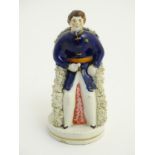 A Victorian Staffordshire portrait figure of Prince Albert seated on a circular gilt lined base.