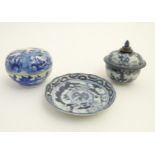 A Chinese blue and white lidded pot decorated with figures in a natural landscape,