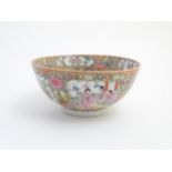 A Cantonese famille rose bowl with hand painted decoration depicting figurative panels, insects,