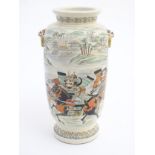 An oriental satsuma vase with hand painted decoration depicting figures dueling on horseback in an