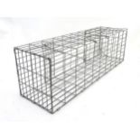 A 20thC steel cage humane catch-and-release squirrel trap, 30" long, 9" wide,