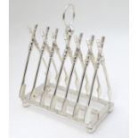 A 21stC silver plate novelty toast rack, the bars formed as crossed oars.