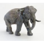 A large silver model of a striding elephant, 9 3/4" tall, 13 3/4" long, 6 1/2" wide,