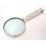 A magnifying glass with handle formed as a golf bag and clubs 9 1/2" long CONDITION: