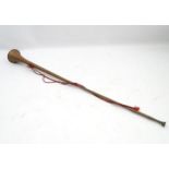 A mid-20thC copper postal/heralding horn, with applied scarlet strap,
