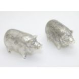 A pair of Novelty white metal pepperettes formed as pigs. 21stC.