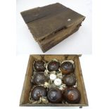 A set of eight Victorian lignum vitae lawn bowls, each with inset ivory roundels (in pairs: I, II,