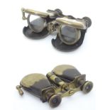 Shooting: a pair of early 20thC folding pocket binoculars, the drums formed as powder flasks.