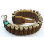 Shooting: A vintage leather & canvas cartridge belt,