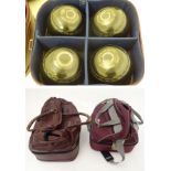 Two sets of four lawn bowls in carrying cases, comprising four composite ('Lignoid') bowls, size 5,