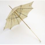 A child's silk parasol with ivory handle and ferule.