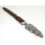 A page turner with faux tortoiseshell blade and acanthus formed silver plate handle 12" long