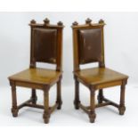 A pair of mid 19thC oak Pugin inspired chairs with trefoil carved cresting rail,