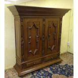 A late 20thC oak hall cupboard / housekeepers cupboard with large moulded cornice,