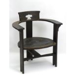 An Arts and Crafts ebonised open armchair in the manner of M.