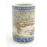 A Chinese famille rose brush pot depicting a winter/snowy landscape,