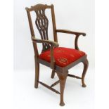 A late 19thC mahogany open armchair with shaped top rail, pierced vase shaped back splat,