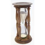 Hour Glass / sand timer: a treen and glass 5 1/2 minute egg timer, 6 1/2" high.