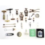 A box containing a large assortment of corkscrews, some drinks stirrers,