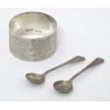 A silver napkin ring with textured decoration hallmarked Birmingham 1972 maker Harman Brothers,
