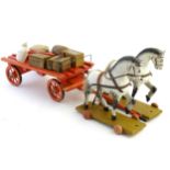 Two early 20thC carved and painted wooden horses on a wheeled bases,